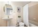Updated bathroom with a white pedestal sink, framed art and wood-look floors at 6000 W Floyd Ave # 307, Denver, CO 80227