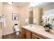 Charming bathroom with single sink vanity, decorative mirror and a shower at 6000 W Floyd Ave # 307, Denver, CO 80227