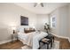 Bedroom featuring a ceiling fan, hardwood floors, and well-lit interior at 6000 W Floyd Ave # 307, Denver, CO 80227