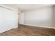 Spacious bedroom with hardwood floors, neutral walls, closet, and bright lighting at 6000 W Floyd Ave # 307, Denver, CO 80227