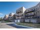 Long shot of condo building with balconies and garage doors on the front at 6000 W Floyd Ave # 307, Denver, CO 80227