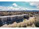 Exterior view of a modern apartment building with private balconies and mountain views at 6000 W Floyd Ave # 307, Denver, CO 80227