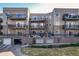 Multi-level apartment complex with multiple balconies, garage and courtyard views at 6000 W Floyd Ave # 307, Denver, CO 80227