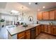 Open kitchen with skylight, leading to living area and balcony with natural light at 6000 W Floyd Ave # 307, Denver, CO 80227