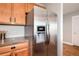 Stainless steel refrigerator and wood cabinets at 6000 W Floyd Ave # 307, Denver, CO 80227