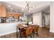 Dining area and kitchen with wooden cabinets and hardwood floors at 6000 W Floyd Ave # 307, Denver, CO 80227