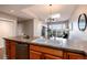 Kitchen island with a sink and stainless steel dishwasher at 6000 W Floyd Ave # 307, Denver, CO 80227