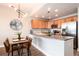Open-concept kitchen with stainless steel appliances and dining table at 6000 W Floyd Ave # 307, Denver, CO 80227