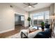Bright living room with wood floors, large windows with a view, and stylish modern furniture at 6000 W Floyd Ave # 307, Denver, CO 80227