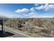 A lush landscape of tall trees provides privacy and beauty from this apartment balcony at 6000 W Floyd Ave # 307, Denver, CO 80227