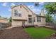 Back exterior with deck, small yard and proximity to mature trees at 4592 Malaya St, Denver, CO 80249