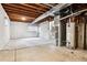 Unfinished basement with exposed ceiling, concrete walls, and utility systems at 4592 Malaya St, Denver, CO 80249