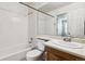 Bright bathroom with subway tile shower, white fixtures, and a vanity at 4592 Malaya St, Denver, CO 80249