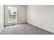 Bright bedroom featuring a window with blinds and neutral carpeting at 4592 Malaya St, Denver, CO 80249