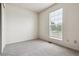 Cozy bedroom with window providing natural light and soft, neutral carpeting at 4592 Malaya St, Denver, CO 80249