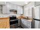 Bright kitchen featuring gray cabinets, stainless steel appliances, and wooden countertops at 4592 Malaya St, Denver, CO 80249