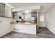 Bright open kitchen with gray cabinetry, stainless steel appliances, and hardwood countertops at 4592 Malaya St, Denver, CO 80249