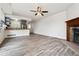 Open-concept living space showcasing hardwood floors, fireplace, and adjacent kitchen area at 4592 Malaya St, Denver, CO 80249