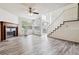 Bright and open living room featuring a wood-burning fireplace and hardwood flooring at 4592 Malaya St, Denver, CO 80249