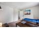 This bedroom features a low bed, functional desk, and ample closet space, perfect for minimal living at 1216 S Uvalda St, Aurora, CO 80012