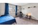 Comfortable bedroom with large window, work desk, and carpeted floors, bathed in natural light at 1216 S Uvalda St, Aurora, CO 80012