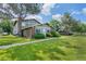 Charming front exterior with lush green lawn, mature tree, and well-maintained landscaping at 1216 S Uvalda St, Aurora, CO 80012