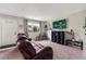 Comfortable living room with neutral carpet, a TV, and a sunlit window for a cozy atmosphere at 1216 S Uvalda St, Aurora, CO 80012