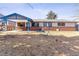 Expansive backyard showcasing a covered patio and open lawn area, ideal for entertaining and recreation at 3762 S Fenton Way, Denver, CO 80235