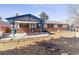 Inviting backyard with a covered patio, brick accents, and space for outdoor activities at 3762 S Fenton Way, Denver, CO 80235