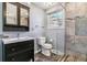 Stylish bathroom featuring a glass shower, unique vanity, and tiled floor at 3762 S Fenton Way, Denver, CO 80235