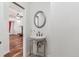 Powder room featuring a pedestal sink with a chrome frame and an oval mirror at 3762 S Fenton Way, Denver, CO 80235