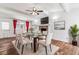 Bright dining room boasts a glass table, modern chairs, fireplace, and vaulted ceilings at 3762 S Fenton Way, Denver, CO 80235