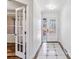 Foyer with decorative front door, tile floor and glass paned interior doors at 3762 S Fenton Way, Denver, CO 80235