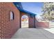 The front porch is made of brick with a blue overhang. There's also a window on the left-hand side at 3762 S Fenton Way, Denver, CO 80235