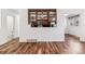 Kitchen featuring custom glass cabinets, stainless steel sink and hardwood floors at 3762 S Fenton Way, Denver, CO 80235