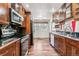 This traditional-style kitchen features wooden cabinets, stainless appliances, and warm lighting at 3762 S Fenton Way, Denver, CO 80235