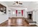 Bright living room featuring hardwood floors, fireplace and ceiling fan at 3762 S Fenton Way, Denver, CO 80235