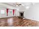 Spacious living room featuring vaulted ceilings, wood floors, fireplace, and ample natural light at 3762 S Fenton Way, Denver, CO 80235