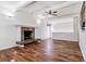 Bright and airy living room with vaulted ceilings, wood floors, and a cozy stone fireplace at 3762 S Fenton Way, Denver, CO 80235