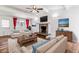 Inviting living room featuring a stone fireplace, hardwood floors, and ample natural light at 3762 S Fenton Way, Denver, CO 80235