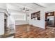 Open-concept living area featuring wood floors, vaulted ceilings, and a partial kitchen view at 3762 S Fenton Way, Denver, CO 80235