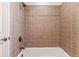 Close up of the bathtub and shower showing decorative tile surround at 3762 S Fenton Way, Denver, CO 80235