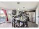 Modern kitchen with dark cabinets, stainless steel appliances, and a granite island with seating at 9990 Jasper St, Commerce City, CO 80022