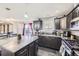 Well-equipped kitchen with granite countertops, dark cabinetry, and an island with room for meal preparation at 9990 Jasper St, Commerce City, CO 80022