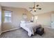 Bright main bedroom with vaulted ceilings, a ceiling fan, and a glimpse into the en-suite bathroom at 9990 Jasper St, Commerce City, CO 80022