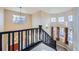 View of the house staircase with dark wood and multiple windows allowing for lots of light at 9990 Jasper St, Commerce City, CO 80022