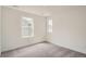 Neutral carpeted bedroom with natural light from two sunny windows at 15277 Fillmore St, Thornton, CO 80602