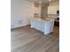 Modern kitchen features wood flooring, a center island, granite countertops and stainless steel appliances at 15277 Fillmore St, Thornton, CO 80602