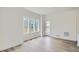 Bright living room with hardwood floors, large windows, and a glass door to the backyard at 15277 Fillmore St, Thornton, CO 80602
