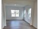 Bright living room with hardwood floors, recessed lighting, and large windows offering natural light at 15277 Fillmore St, Thornton, CO 80602